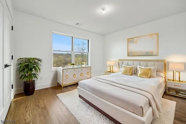a bedroom with a bed and a potted plant