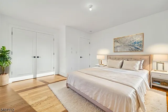 a spacious bedroom with a bed and a potted plant