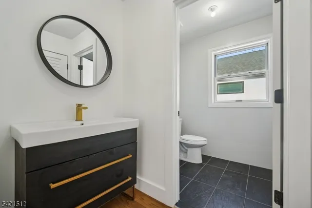 a bathroom with a toilet a sink and a mirror