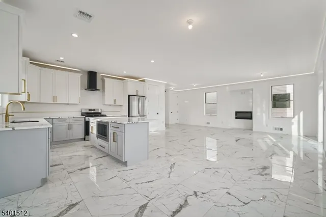 a large white kitchen with white cabinets and white appliances
