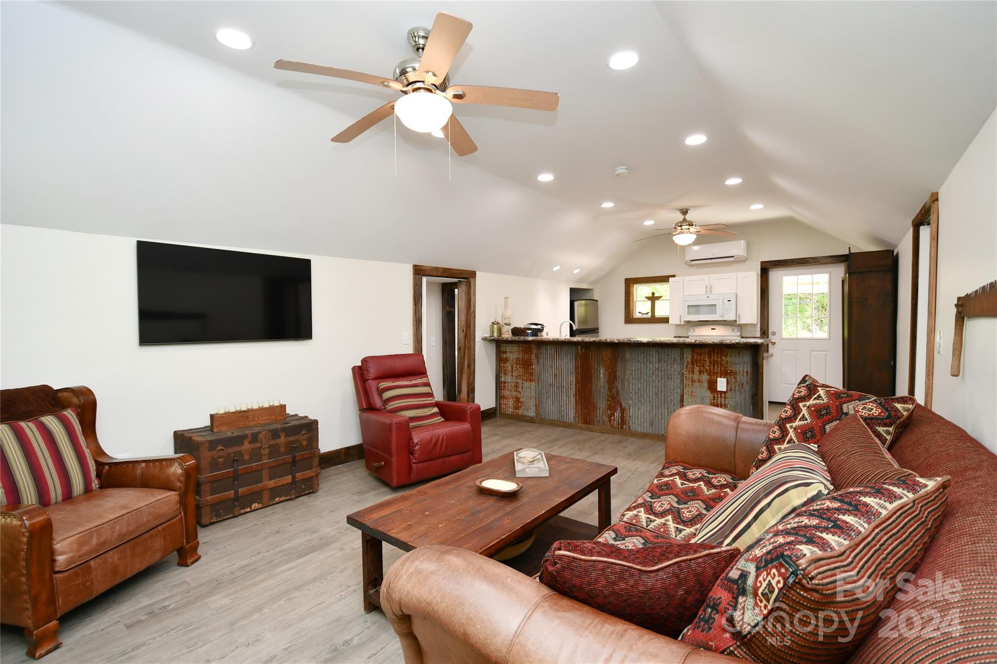 2180 Pigeon Roost Road Green Mountain, NC 28740 - Photo 11 of 47 a living room with furniture a flat screen tv and kitchen view