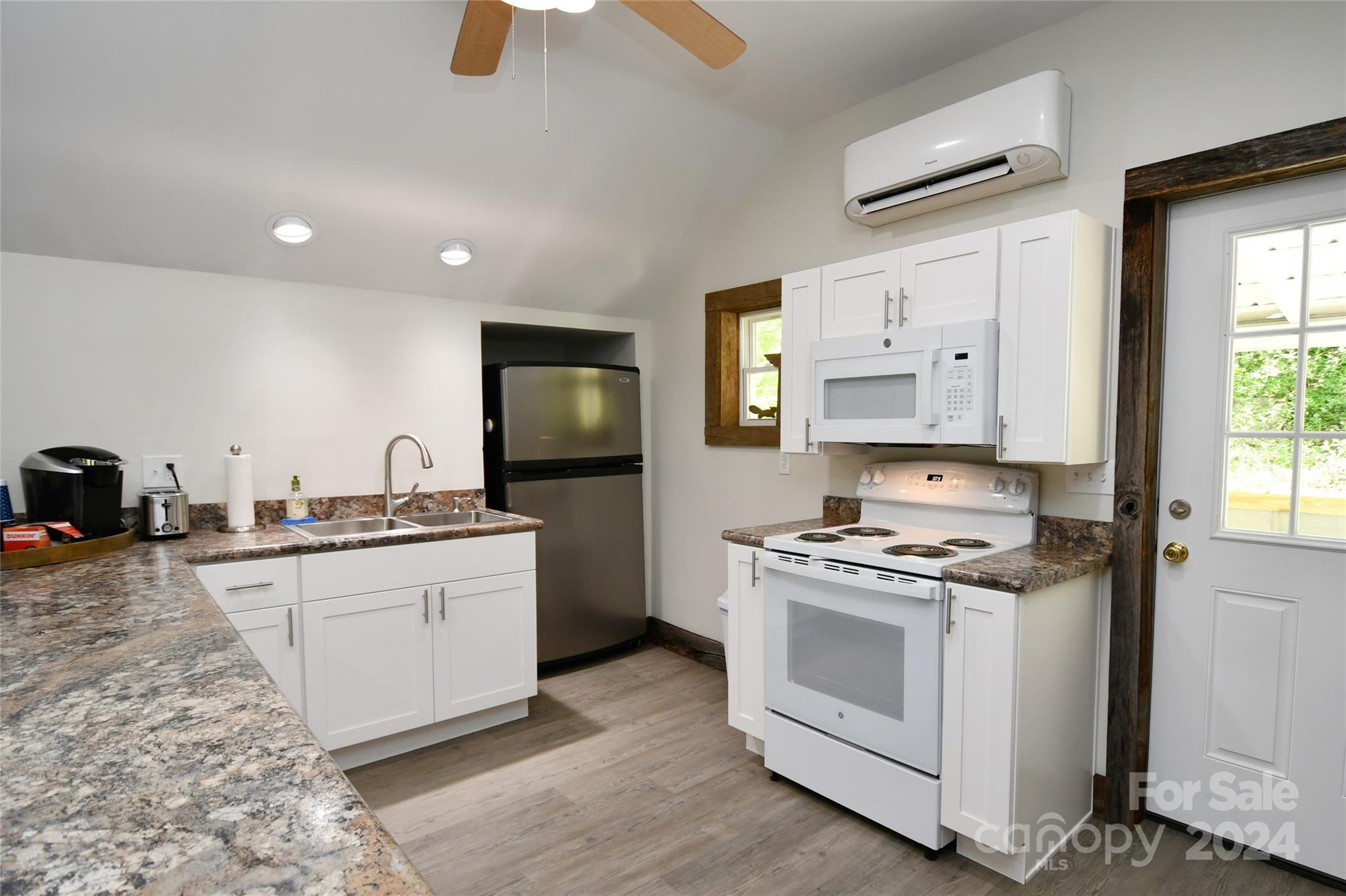2180 Pigeon Roost Road Green Mountain, NC 28740 - Photo 15 of 47 a kitchen with stainless steel appliances granite countertop a stove a sink and a refrigerator