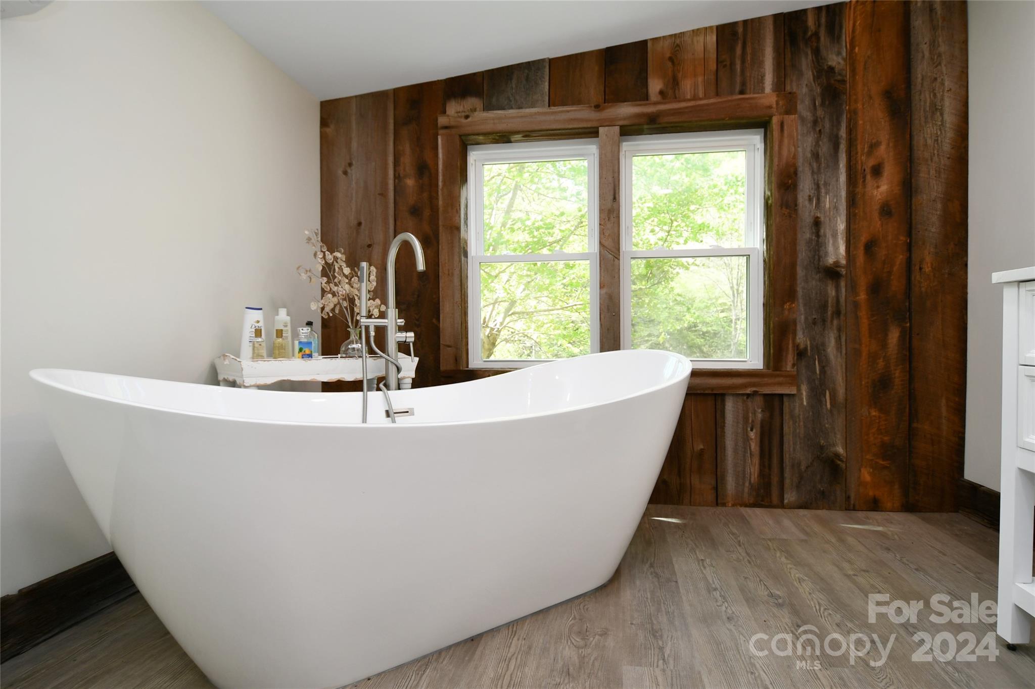 2180 Pigeon Roost Road Green Mountain, NC 28740 - Photo 17 of 47 a white bath tub sitting in a bathroom next to a window