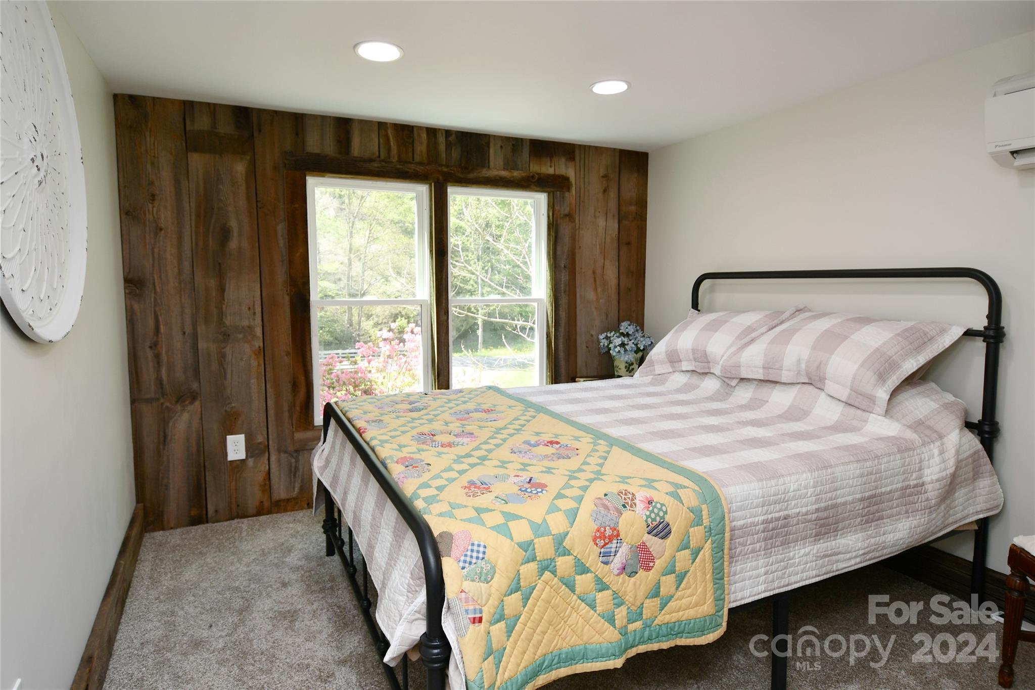 2180 Pigeon Roost Road Green Mountain, NC 28740 - Photo 19 of 47 a bedroom with a bed and a large window