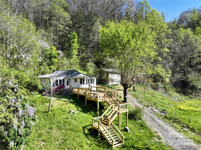 a roof deck with table and chairs and potted plants