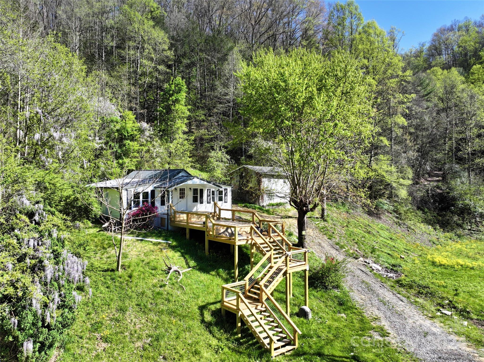 2180 Pigeon Roost Road Green Mountain, NC 28740 - Photo 21 of 47 a roof deck with table and chairs and potted plants