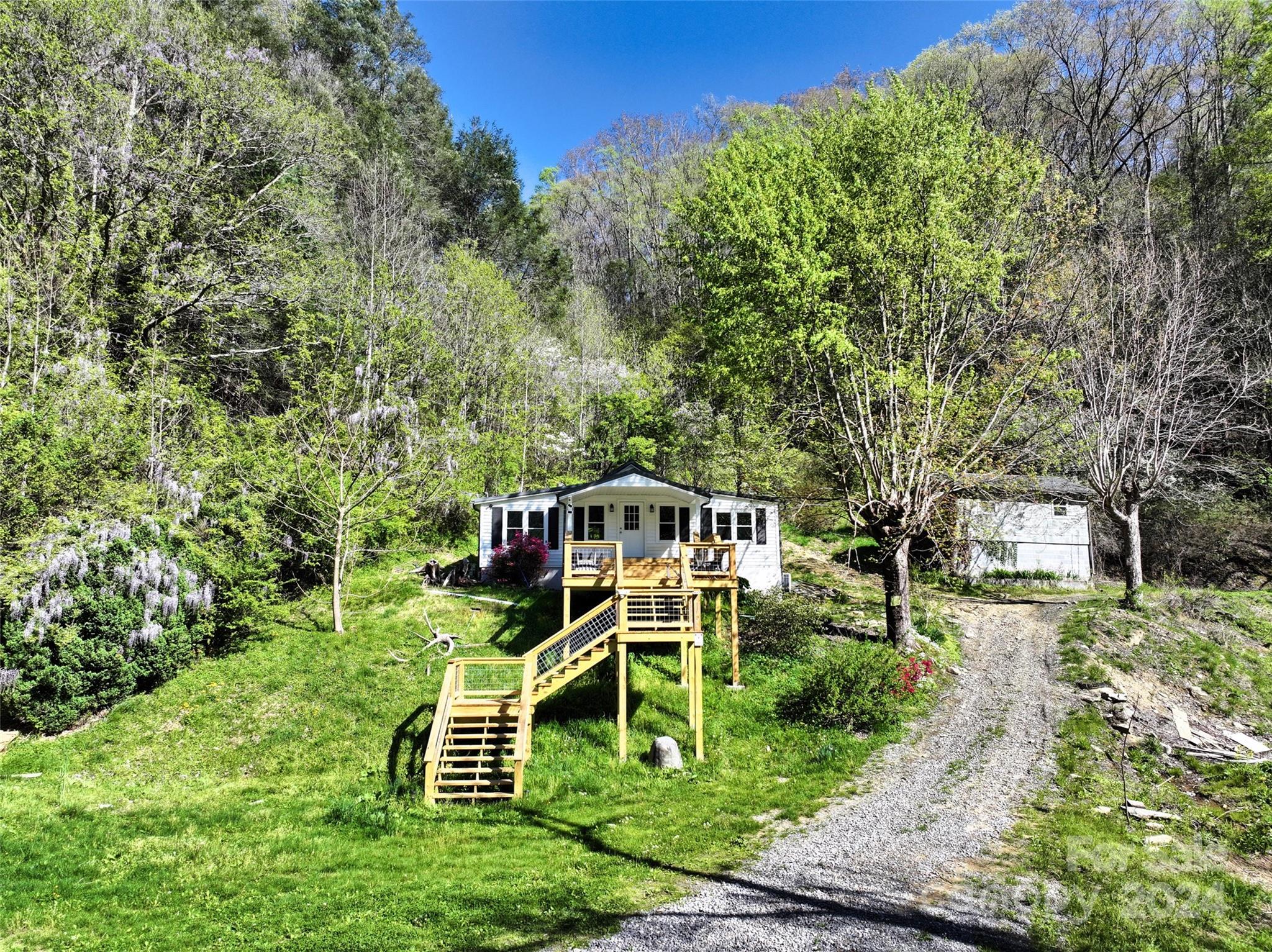 2180 Pigeon Roost Road Green Mountain, NC 28740 - Photo 22 of 47 a front view of a house with a yard