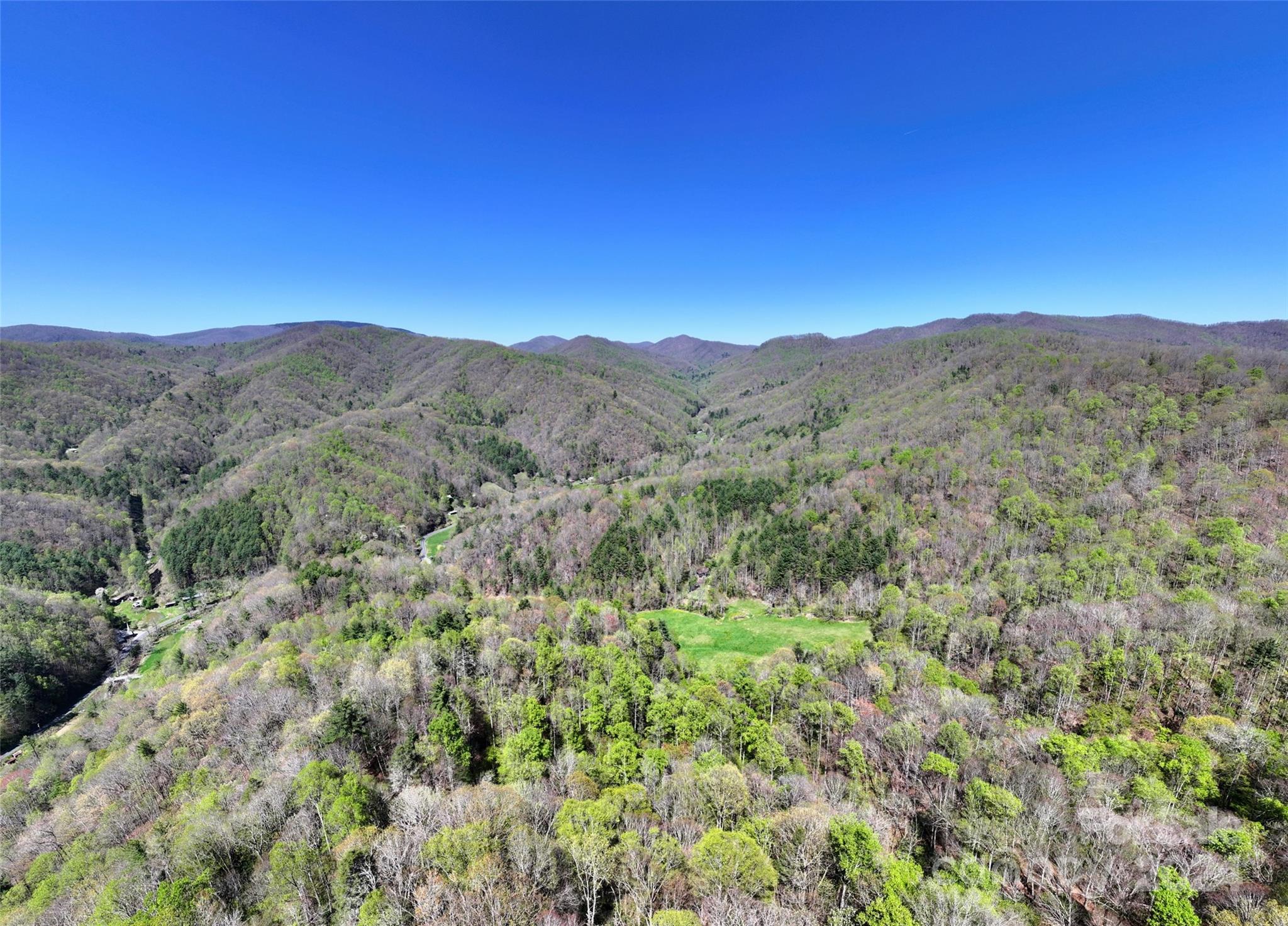 2180 Pigeon Roost Road Green Mountain, NC 28740 - Photo 38 of 47 a view of a mountain range with lush green forest