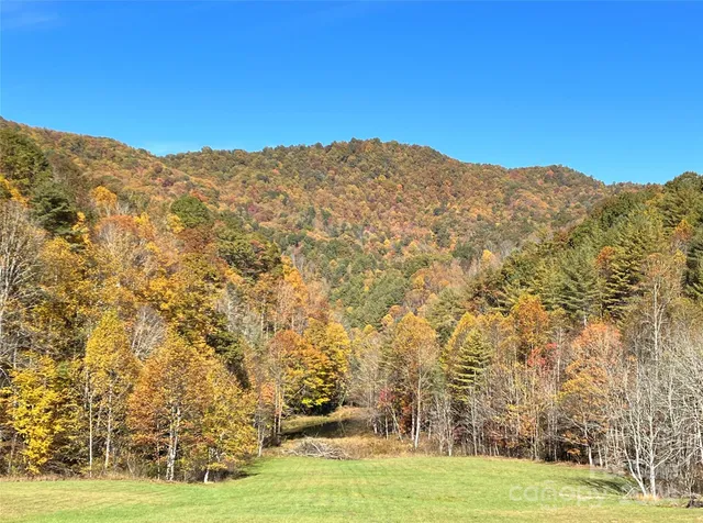 a view of mountain with a field