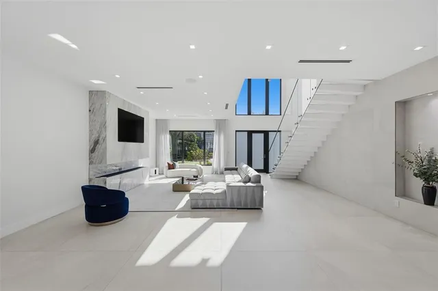 a view of a dining room with furniture and large windows