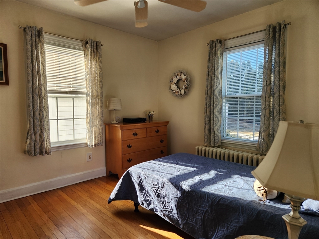 350 Thompson Road Webster, MA 01570 - Photo 6 of 41 a bedroom with a bed and wooden floor