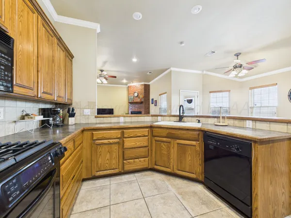 a kitchen with stainless steel appliances granite countertop a stove sink and cabinets