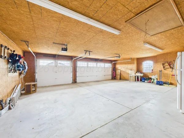 a view of a livingroom with furniture and a refrigerator