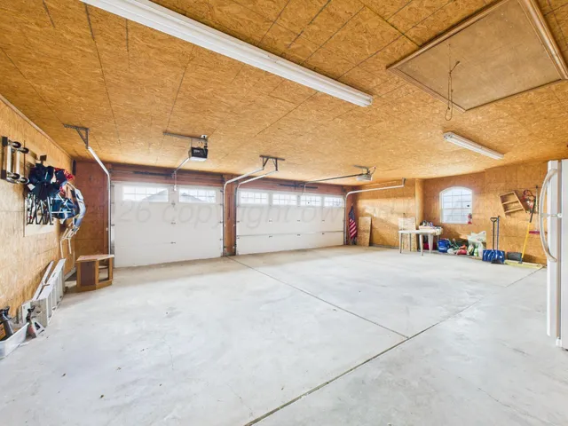 a view of a livingroom with furniture and a refrigerator
