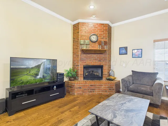 a living room with fireplace furniture and a flat screen tv