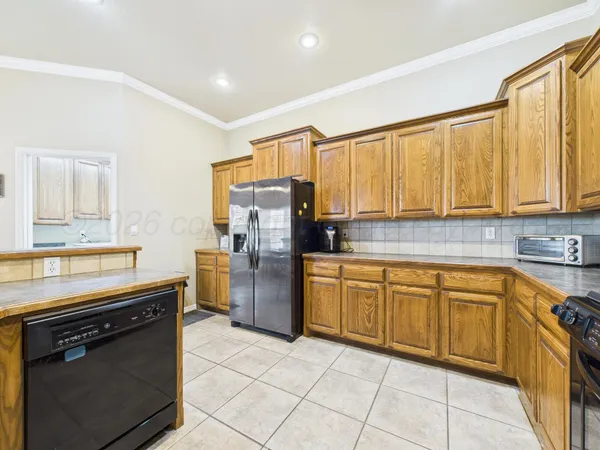 a large kitchen with stainless steel appliances granite countertop a stove sink and cabinets