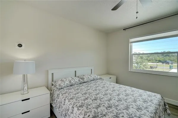 a bedroom with a bed and a window