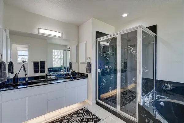 a bathroom with a double vanity sink and shower