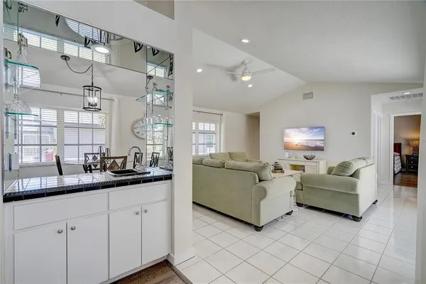 a living room with furniture and a large mirror