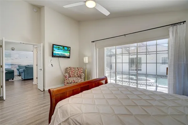 a bedroom with a large bed and a chandelier