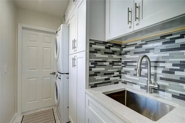 a view of a kitchen with a sink and refrigerator