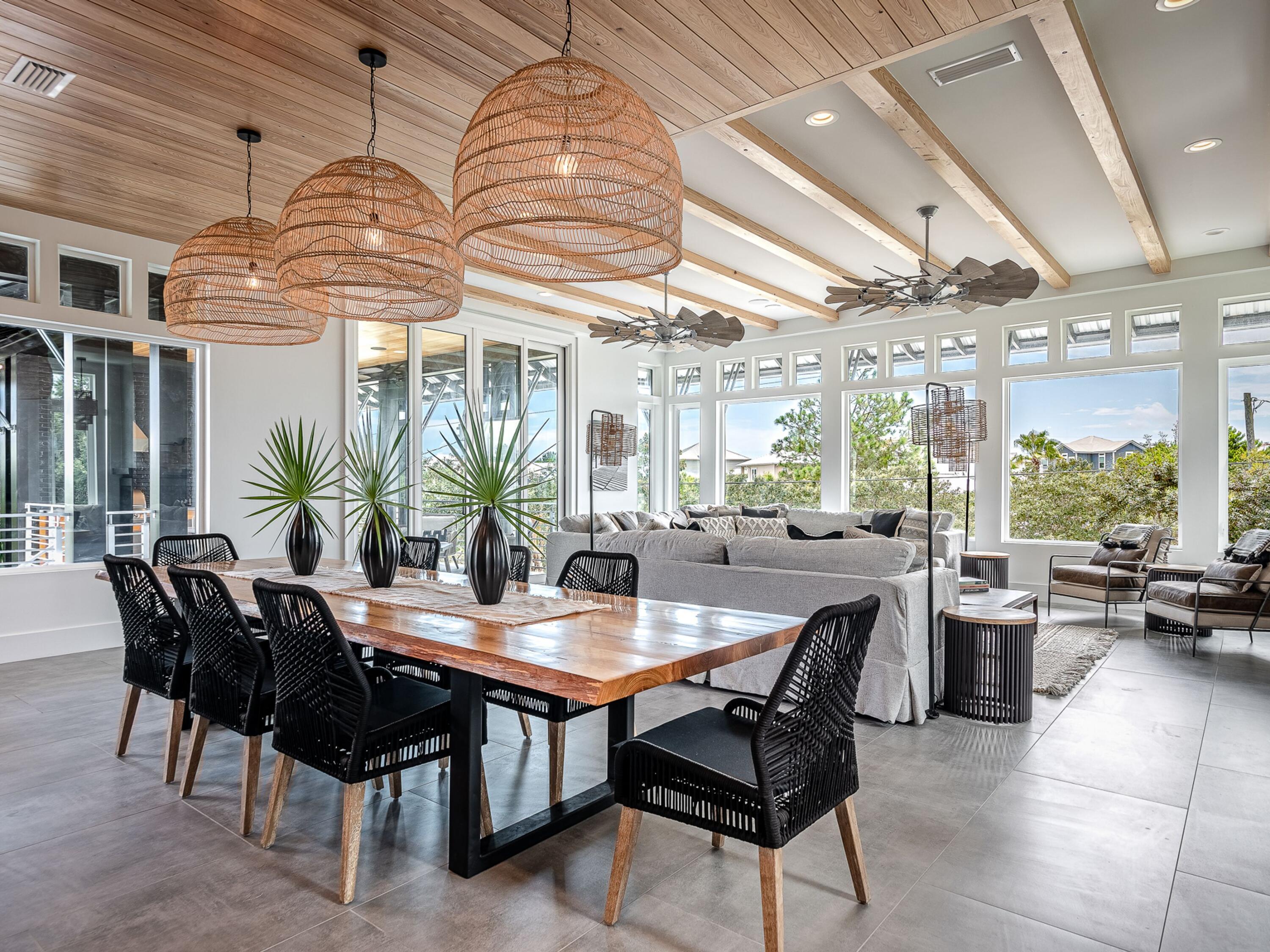 124 Hilltop Drive Santa Rosa Beach, FL 32459 - Photo 51 of 65 a dining room with wooden floor a chandelier a wooden table and chairs