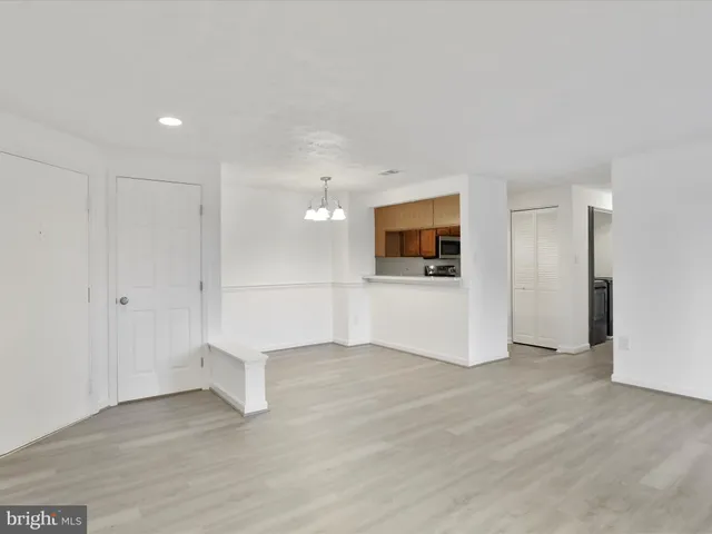 a view of a utility room with wooden floor and staircase