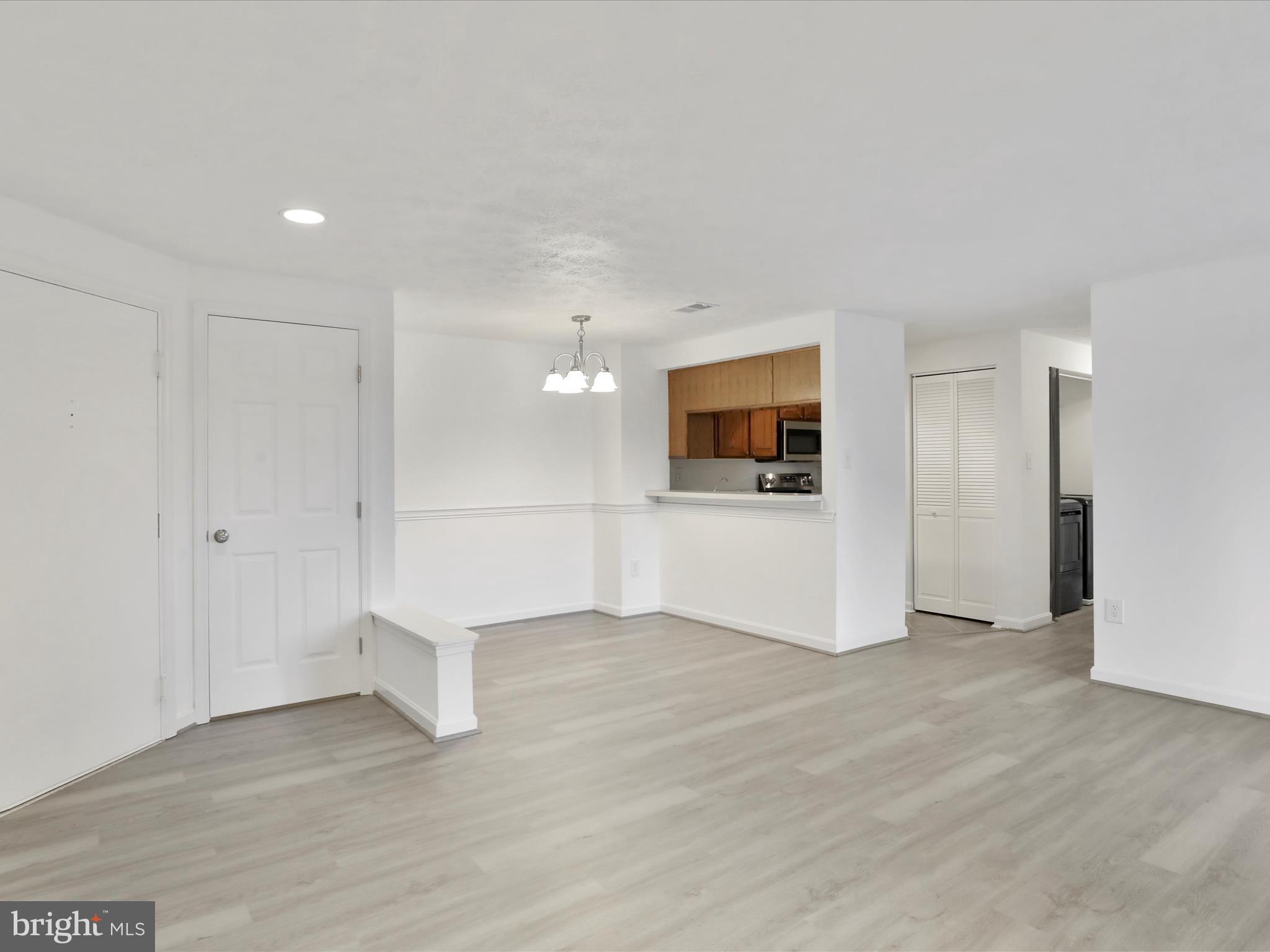 811 Stratford Way, Unit D Frederick, MD 21701 - Photo 6 of 25 a view of a kitchen with an empty room and a kitchen