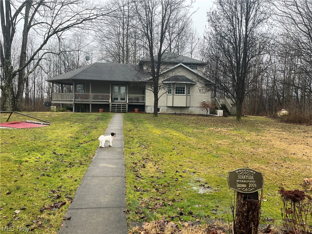 72895 Irish Ridge Road Kimbolton, OH 43749 - Photo 10 of 21 View of front of home featuring central AC, a front yard, and a porch