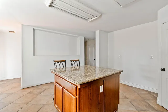 a view of an empty room with a fireplace and a window
