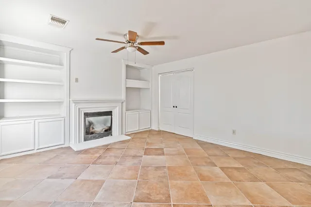 a view of a livingroom with a ceiling fan and window