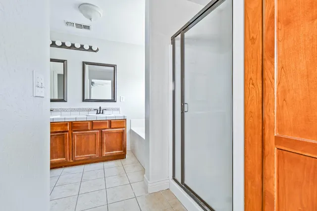 a en suite bathroom with a granite countertop sink