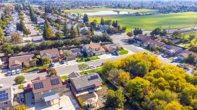 an aerial view of a house with a garden and swimming pool