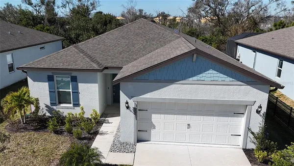 a view of a big room with wooden floor and windows
