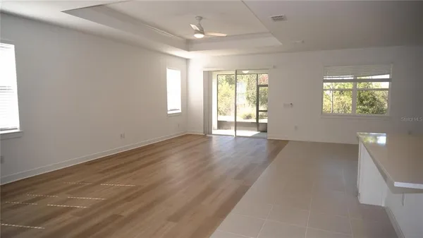 a kitchen with white cabinets and black appliances
