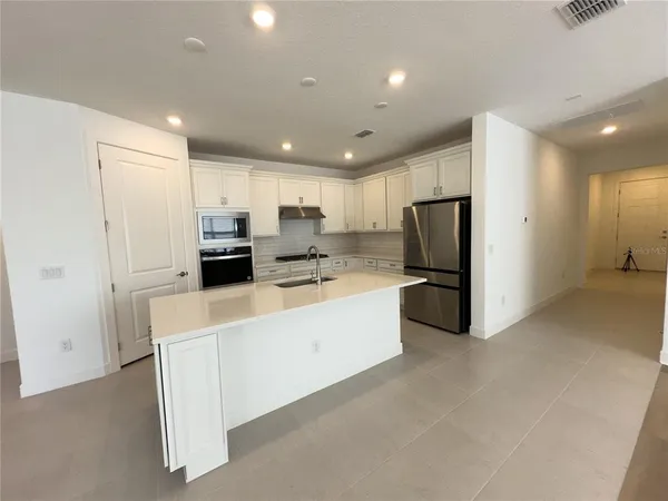 a kitchen with stainless steel appliances granite countertop a sink and a window