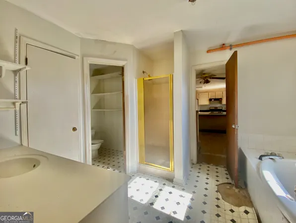 a bathroom with a bathtub and a shower