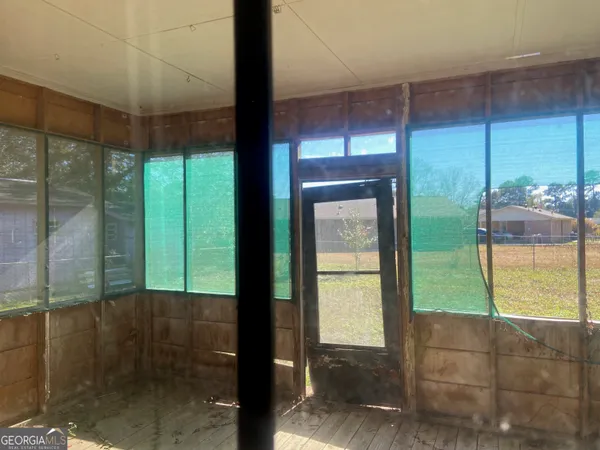 a view of a wooden door and a yard