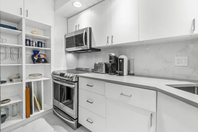 a kitchen with stainless steel appliances granite countertop a sink and a stove