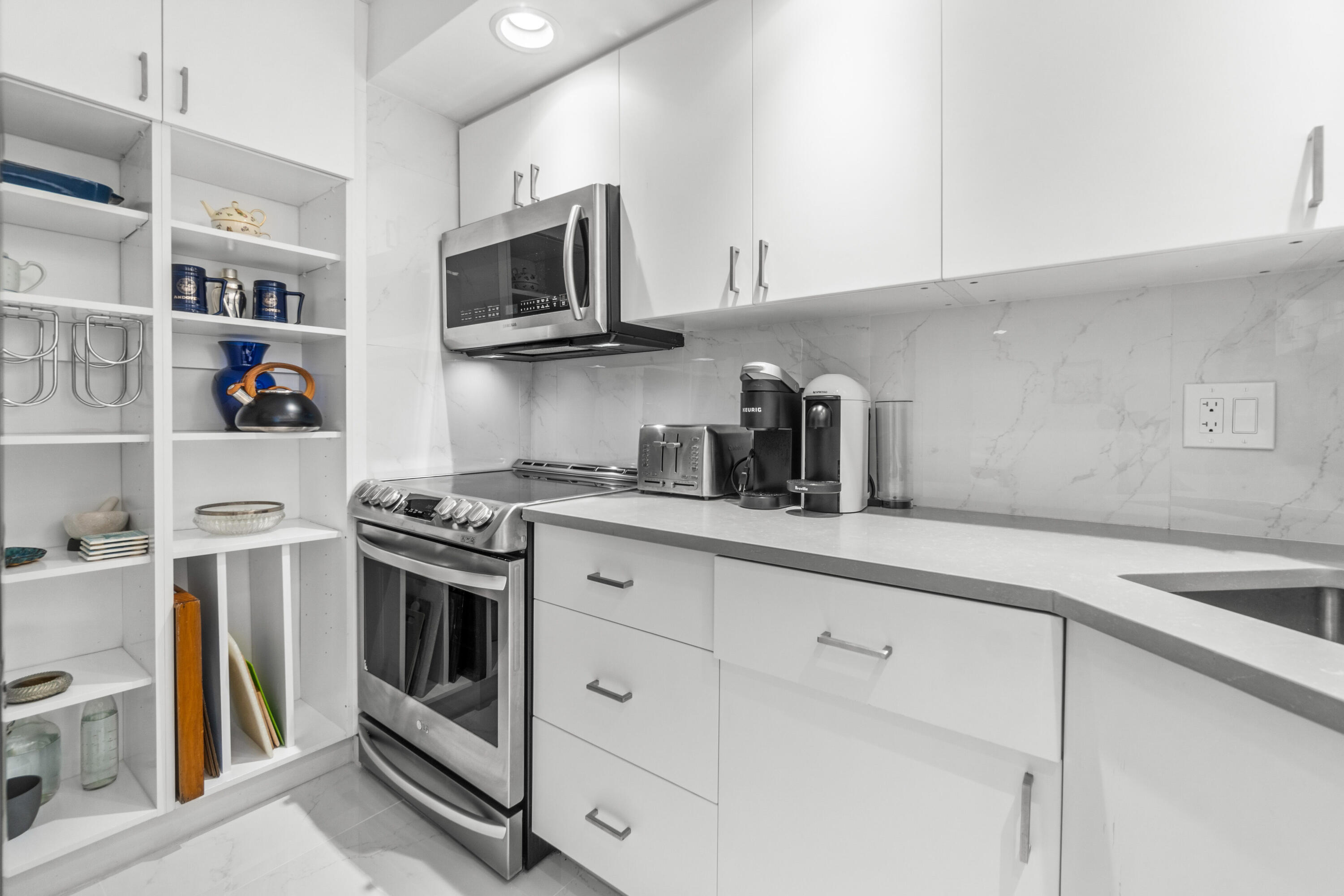 2780 South Ocean Boulevard, Unit 306 Palm Beach, FL 33480 - Photo 14 of 37 a kitchen with stainless steel appliances granite countertop a sink and a stove