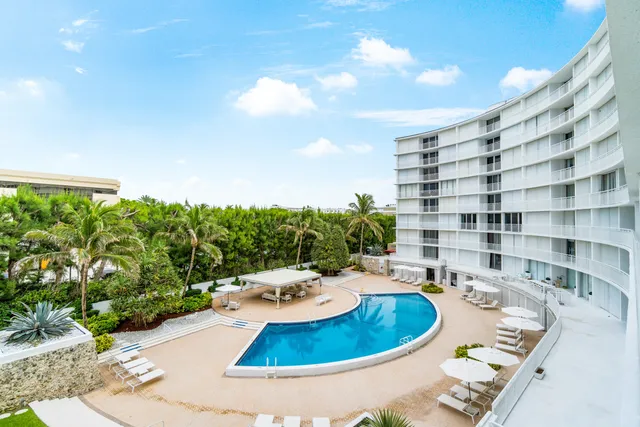 a view of a swimming pool with outdoor seating