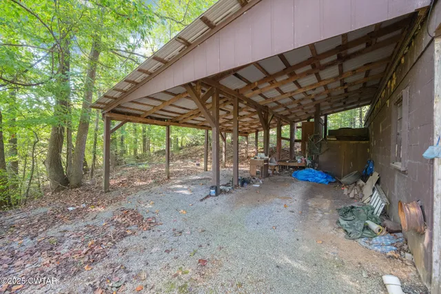 a view of a backyard with large trees