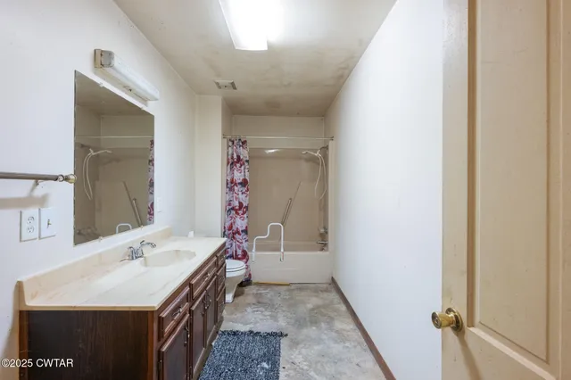 a bathroom with a sink a mirror and a toilet