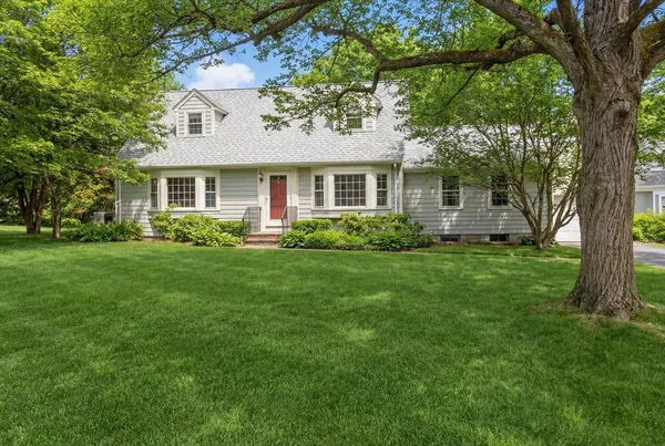a front view of house with yard and green space