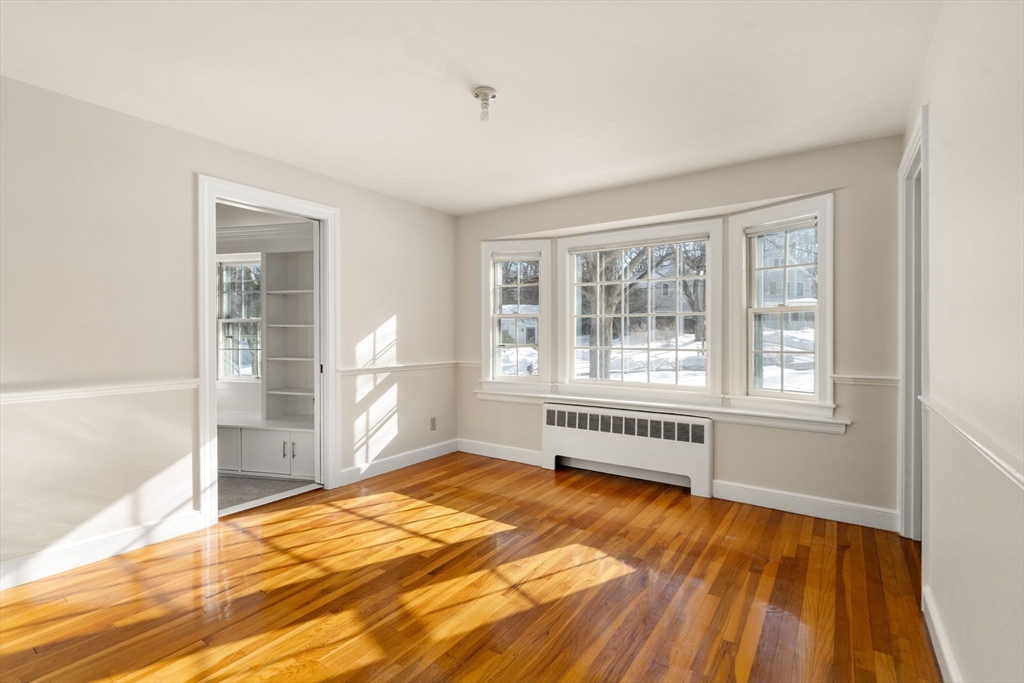 101 Adams Road Concord, MA 01742 - Photo 11 of 26 a view of an empty room with wooden floor and a window