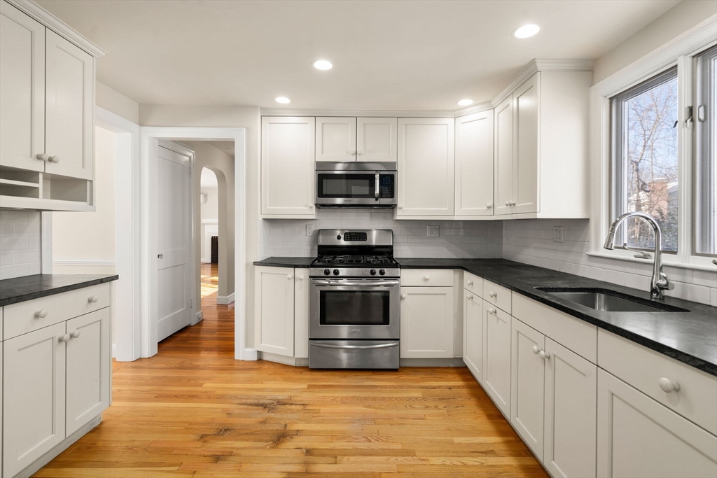 101 Adams Road Concord, MA 01742 - Photo 16 of 26 a kitchen with stainless steel appliances granite countertop a stove and a sink
