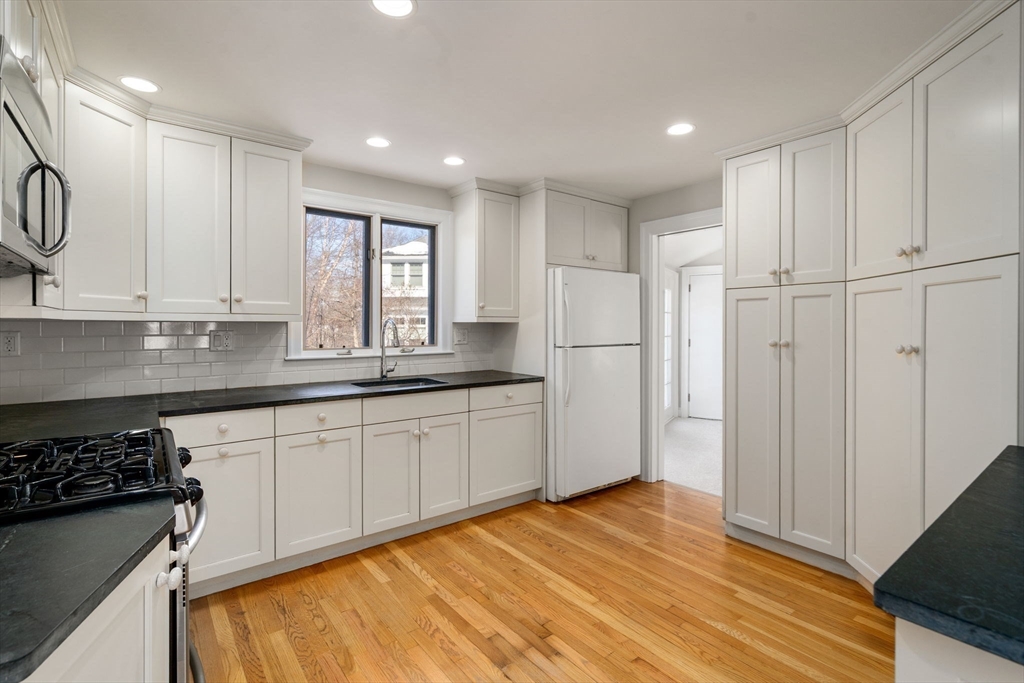 101 Adams Road Concord, MA 01742 - Photo 17 of 26 a kitchen with stainless steel appliances granite countertop a refrigerator and a stove top oven
