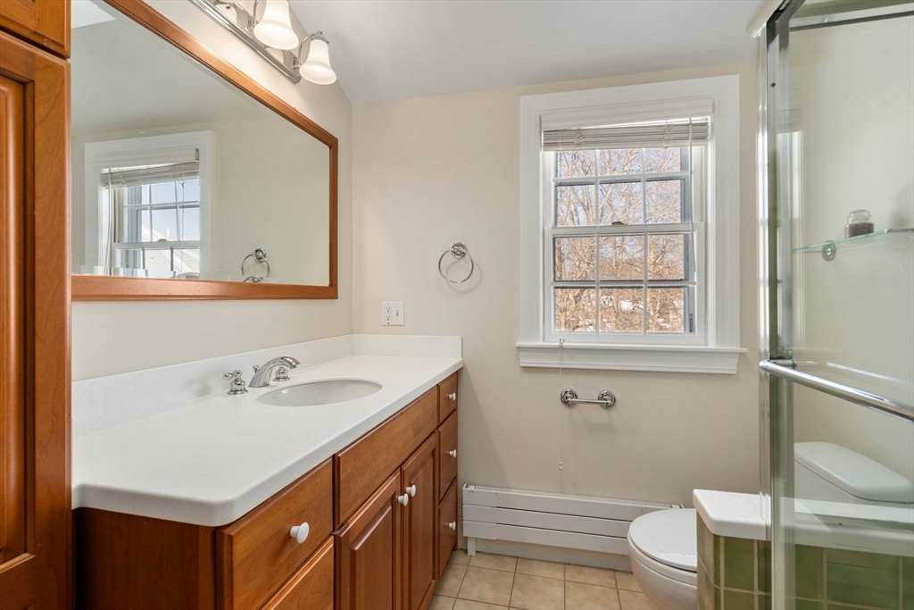 101 Adams Road Concord, MA 01742 - Photo 23 of 26 a bathroom with a sink a toilet and shower