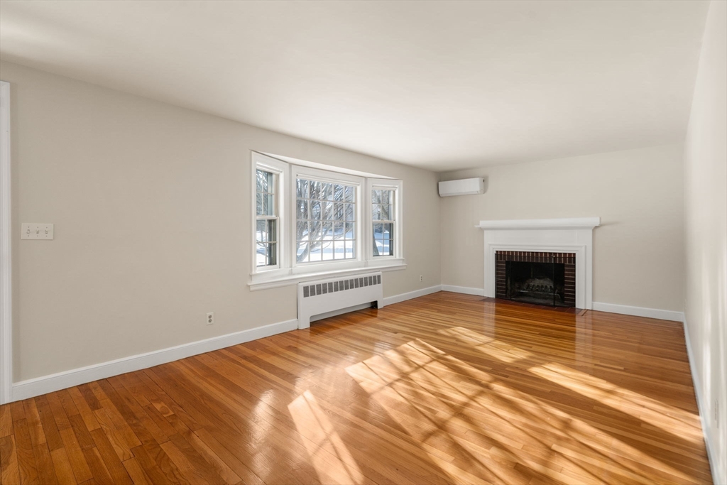 101 Adams Road Concord, MA 01742 - Photo 8 of 26 a view of an empty room with a window and fireplace