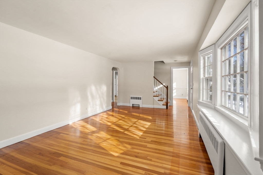 101 Adams Road Concord, MA 01742 - Photo 9 of 26 a view of a room with wooden floor and a floor to ceiling window